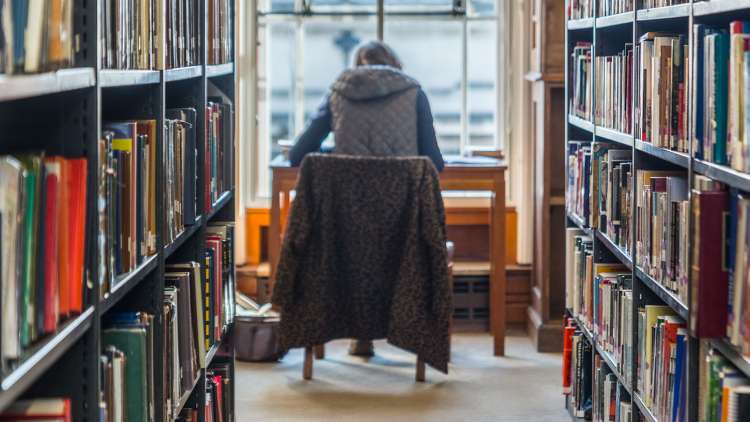 Student sat at desk in SHL reading room