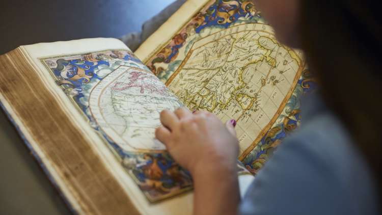 Image of a reader browsing through a Special Collections book