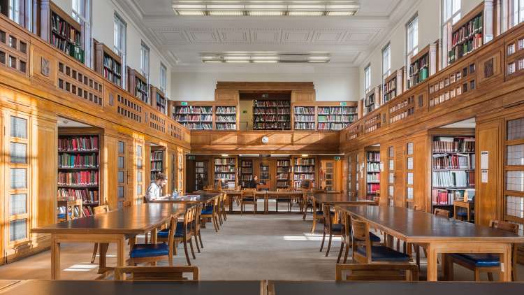 Senate House Library reading room with morning sun hitting the desks
