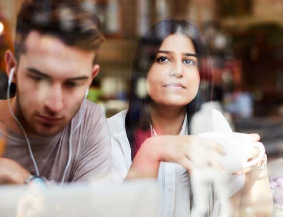 Sitting in the café listening to music and drinking coffee