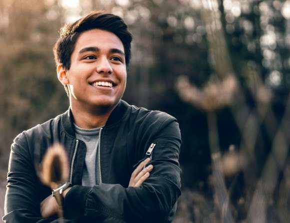 A smiling man standing in a field